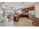Open concept kitchen with stainless steel appliances, dark wood cabinets, and a view to the living area at 6327 Ashley Dr, Lakeland, FL 33813