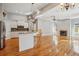 Open concept kitchen and living room with bar seating, ceiling fan, and a fireplace at 6327 Ashley Dr, Lakeland, FL 33813