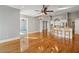 Open floor plan with hardwood floors, ceiling fan, and bar seating perfect for entertaining guests at 6327 Ashley Dr, Lakeland, FL 33813