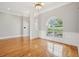 Bright living room with hardwood floors, white trim, and a large arched window providing ample natural light at 6327 Ashley Dr, Lakeland, FL 33813