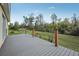 Beautiful rear deck with wood railings and backyard with mature trees and landscaping at 6327 Ashley Dr, Lakeland, FL 33813