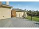 View of rear deck and guest house/garage with gray decking and a view of the lush backyard at 6327 Ashley Dr, Lakeland, FL 33813
