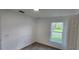 Well-lit bedroom with neutral carpet, white walls, and a window offering neighborhood views at 1404 Country Chase Dr, Lakeland, FL 33810