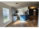 Inviting living space showcasing a modern kitchen with stainless steel appliances, tile backsplash, and sleek floors at 1404 Country Chase Dr, Lakeland, FL 33810