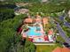 An aerial view shows the pool, splash pad, clubhouse, and manicured landscaping of the community at 8010 Tuscany Way # 5301, Davenport, FL 33896