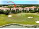 Aerial view of condominium complex near golf course with lush green landscaping at 8010 Tuscany Way # 5301, Davenport, FL 33896