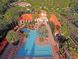 Aerial view of large pool surrounded by lounge chairs, lush landscaping and community at 8010 Tuscany Way # 5301, Davenport, FL 33896