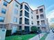 Low angle view of condominium with stone accents, multiple balconies and landscaping at 8010 Tuscany Way # 5301, Davenport, FL 33896