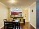 Dining room view leading to kitchen with bar top, with hardwood floors, open to the living spaces at 8010 Tuscany Way # 5301, Davenport, FL 33896