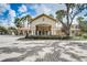 A beautiful clubhouse entrance with palm trees, gated entrance, and detailed architecture at 8010 Tuscany Way # 5301, Davenport, FL 33896