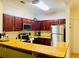 Kitchen with stainless steel appliances, granite countertops, and wooden cabinets at 8010 Tuscany Way # 5301, Davenport, FL 33896