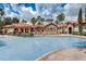 Large community swimming pool, surrounded by lounge chairs and beautiful landscaping at 8010 Tuscany Way # 5301, Davenport, FL 33896