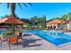 Community pool with lounge seating and tables for outdoor dining at 8010 Tuscany Way # 5301, Davenport, FL 33896