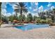 Resort-style pool surrounded by palm trees, lounge seating, and cabanas for ultimate relaxation at 8010 Tuscany Way # 5301, Davenport, FL 33896