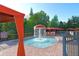 Fun splash pad area featuring a fountain, covered lounge seating, and a surrounding fence for safety at 8010 Tuscany Way # 5301, Davenport, FL 33896