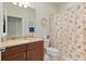 Bathroom features a granite-topped vanity and a shower with decorative curtain at 9761 Sw 74Th Pl, Ocala, FL 34481