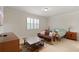 Comfortable bedroom with a seating area, TV, and a large window with plantation shutters at 9761 Sw 74Th Pl, Ocala, FL 34481