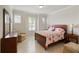 Bright bedroom with three shuttered windows, tile floor, and traditional wood furniture at 9761 Sw 74Th Pl, Ocala, FL 34481