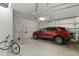 Well-lit garage with car, bike, storage racks, and ample space for parking and hobbies at 9761 Sw 74Th Pl, Ocala, FL 34481