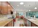 Open concept kitchen with wooden cabinets, granite counters, and a view to the dining area at 9761 Sw 74Th Pl, Ocala, FL 34481