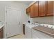 A laundry room with a utility sink, washer, and dryer at 9761 Sw 74Th Pl, Ocala, FL 34481