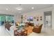 Living room with tile floors, neutral paint, bright windows and comfortable seating at 9761 Sw 74Th Pl, Ocala, FL 34481