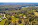 Serene aerial shot featuring a lake surrounded by mature trees and several buildings at 4942 Cr 300, Lake Panasoffkee, FL 33538