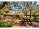 Multi-level backyard deck featuring a picnic table, lush greenery, and ample space for outdoor enjoyment at 4942 Cr 300, Lake Panasoffkee, FL 33538