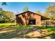 Barn showcasing vehicle storage and a convenient covered parking area on the side at 4942 Cr 300, Lake Panasoffkee, FL 33538