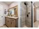 Elegant bathroom featuring wooden cabinets, granite countertops and a modern tiled shower at 4942 Cr 300, Lake Panasoffkee, FL 33538