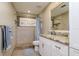 Bathroom featuring tiled walk-in shower, granite counters, and wood-look tiled floor at 4942 Cr 300, Lake Panasoffkee, FL 33538