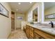 Bright bathroom featuring double vanity, granite countertops, natural wood cabinets and a tiled walk-in shower at 4942 Cr 300, Lake Panasoffkee, FL 33538