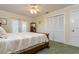 Cozy bedroom featuring plush carpet, white closet doors and shutters for natural light at 4942 Cr 300, Lake Panasoffkee, FL 33538