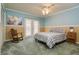 Comfortable bedroom with decorative wainscoting, french doors and a ceiling fan at 4942 Cr 300, Lake Panasoffkee, FL 33538