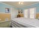 Comfortable bedroom with decorative wainscoting, white closet doors and french doors at 4942 Cr 300, Lake Panasoffkee, FL 33538