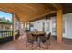 Inviting covered patio featuring a wood ceiling, tile floor, and a dining table with four chairs at 4942 Cr 300, Lake Panasoffkee, FL 33538