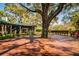 Expansive wooden deck featuring a large tree and ample seating at 4942 Cr 300, Lake Panasoffkee, FL 33538