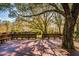 Beautiful deck area shaded by mature trees, furnished with benches for relaxing and enjoying nature at 4942 Cr 300, Lake Panasoffkee, FL 33538