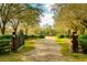 Private gated entrance with a long driveway leading to the property at 4942 Cr 300, Lake Panasoffkee, FL 33538