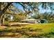 Lovely home with lush green lawn, mature trees, and ample parking at 4942 Cr 300, Lake Panasoffkee, FL 33538