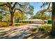 Charming one-story home with a green roof and a brick driveway at 4942 Cr 300, Lake Panasoffkee, FL 33538