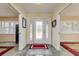 Inviting foyer with decorative glass door and neutral tile flooring at 4942 Cr 300, Lake Panasoffkee, FL 33538