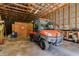 Spacious garage interior featuring a utility vehicle and ample storage space at 4942 Cr 300, Lake Panasoffkee, FL 33538