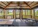 Spacious wood gazebo offering a lattice surround, metal roof, and wooded views at 4942 Cr 300, Lake Panasoffkee, FL 33538