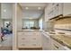 Bright kitchen features stainless steel appliances, granite countertops, and white cabinets at 4942 Cr 300, Lake Panasoffkee, FL 33538
