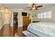 Bedroom with hardwood floors featuring a walk-in closet and ensuite bathroom at 4942 Cr 300, Lake Panasoffkee, FL 33538