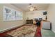 Well-lit office featuring a ceiling fan, a large window with shutters and a decorative rug at 4942 Cr 300, Lake Panasoffkee, FL 33538