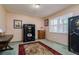 Office space with a large safe, window with shutters, and patterned rug on the floor at 4942 Cr 300, Lake Panasoffkee, FL 33538