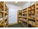 Walk-in pantry features custom wooden shelving, providing ample storage space at 4942 Cr 300, Lake Panasoffkee, FL 33538