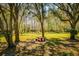 Park area featuring a picnic table, a gazebo, and mature trees at 4942 Cr 300, Lake Panasoffkee, FL 33538